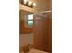 Bathroom featuring a sink, mirror, and pink-tiled shower at 11447 Park Blvd # 301, Seminole, FL 33772