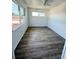 Bright bedroom with wood-look floors and large windows for natural light at 11447 Park Blvd # 301, Seminole, FL 33772
