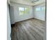 This bright bedroom features wood-look floors and large windows that fill the space with natural light at 11447 Park Blvd # 301, Seminole, FL 33772