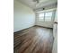 Bright bedroom featuring wood-look floors and natural lighting from a large window at 11447 Park Blvd # 301, Seminole, FL 33772