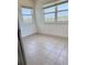 Bright bedroom featuring tile floors, base trim, and large windows allowing ample natural light at 11447 Park Blvd # 301, Seminole, FL 33772