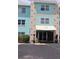 Three-story condo building with fresh exterior paint and attractive landscaping at the entrance at 11447 Park Blvd # 301, Seminole, FL 33772