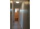 Hallway view to bathroom with pink tile and tile floors at 11447 Park Blvd # 301, Seminole, FL 33772