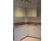 Traditional kitchen with white cabinets, laminate countertops, and a stainless steel sink at 11447 Park Blvd # 301, Seminole, FL 33772