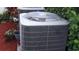 Close-up shot of an air conditioning unit surrounded by mulch and greenery at 11704 Navajo Sandstone St, Riverview, FL 33579