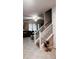 Bright entryway features tile flooring, staircase, and view into the living room at 11704 Navajo Sandstone St, Riverview, FL 33579