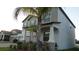 Two story home with gray siding, large covered porch, and lush landscaping creating a welcoming entrance at 11704 Navajo Sandstone St, Riverview, FL 33579