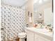 Bright bathroom features a vanity, toilet, and tub/shower with a seashell patterned curtain at 1247 Ocean Reef Rd, Wesley Chapel, FL 33544