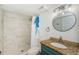 Bathroom featuring marble shower, modern vanity, and elegant fixtures at 1290 Pine Ridge E Cir # G1, Tarpon Springs, FL 34688