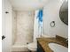 Bright bathroom featuring a marble tiled walk-in shower with pebble floor and granite vanity at 1290 Pine Ridge E Cir # G1, Tarpon Springs, FL 34688