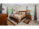 Cozy bedroom with a large bed, neutral decor, and a ceiling fan for comfort at 1290 Pine Ridge E Cir # G1, Tarpon Springs, FL 34688