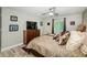 Bedroom featuring a large bed, wood furnishings, and natural light from the window at 1290 Pine Ridge E Cir # G1, Tarpon Springs, FL 34688