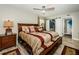 Bedroom featuring a large bed, wood furnishings, and a closet with sliding doors at 1290 Pine Ridge E Cir # G1, Tarpon Springs, FL 34688