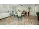 Bright dining area featuring a round glass table, stylish rug, and unique wall decorations at 1290 Pine Ridge E Cir # G1, Tarpon Springs, FL 34688