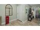 Inviting entryway with light wood floors, decorative accents, and a bright white front door at 1290 Pine Ridge E Cir # G1, Tarpon Springs, FL 34688
