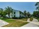 Exterior of well-maintained condo building with lush landscaping, sidewalks, and parking spaces at 1290 Pine Ridge E Cir # G1, Tarpon Springs, FL 34688