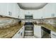Close-up of kitchen featuring stainless steel oven and modern countertops at 1290 Pine Ridge E Cir # G1, Tarpon Springs, FL 34688
