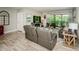 Open living area with comfortable seating, a TV, and access to a screened patio with a view at 1290 Pine Ridge E Cir # G1, Tarpon Springs, FL 34688