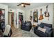 Sitting area featuring comfortable seating, desk, closets and decor guitars at 1290 Pine Ridge E Cir # G1, Tarpon Springs, FL 34688
