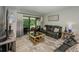 A relaxing living room with sliding glass doors to the patio, comfortable seating and soft light at 1290 Pine Ridge E Cir # G1, Tarpon Springs, FL 34688
