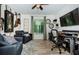 Cozy living room featuring comfortable seating, large TV, window and decorative guitars at 1290 Pine Ridge E Cir # G1, Tarpon Springs, FL 34688