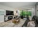 Cozy living room with stylish furniture, a fireplace, and a sliding door to the patio at 1290 Pine Ridge E Cir # G1, Tarpon Springs, FL 34688