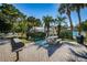 Outdoor picnic area with a table, grill and lush landscaping to enjoy Florida's weather at 1290 Pine Ridge E Cir # G1, Tarpon Springs, FL 34688