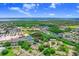 An attractive aerial shot highlighting the condo neighborhood with nearby commercial area and tranquil lakes at 134 Sycamore Ln # F, Oldsmar, FL 34677