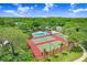 A captivating aerial shot reveals community amenities, a pool, and athletic courts, all embraced by lush greenery at 134 Sycamore Ln # F, Oldsmar, FL 34677