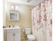 Charming bathroom with decorative shower curtain and a vanity cabinet for storage at 134 Sycamore Ln # F, Oldsmar, FL 34677