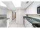 Well-lit kitchen showcasing ample counter space, white cabinetry, and a clean, functional design at 134 Sycamore Ln # F, Oldsmar, FL 34677