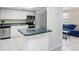 Modern kitchen with stainless steel appliances and a breakfast bar at 134 Sycamore Ln # F, Oldsmar, FL 34677