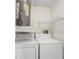 Functional laundry area featuring a washer, dryer, and water heater at 134 Sycamore Ln # F, Oldsmar, FL 34677