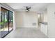 Bright room with sliding glass doors and a bar overlooking the kitchen at 134 Sycamore Ln # F, Oldsmar, FL 34677