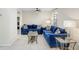 Inviting living room featuring a blue sofas, tile flooring and natural lighting at 134 Sycamore Ln # F, Oldsmar, FL 34677
