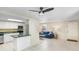 Open concept living room and kitchen featuring tile floors and stainless steel appliances at 134 Sycamore Ln # F, Oldsmar, FL 34677