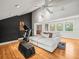 Bright living area featuring hardwood floors, a comfortable sofa, and exercise equipment for a healthy lifestyle at 13801 Lake Village Pl, Tampa, FL 33618