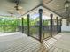 Wide porch with black railings and ceiling fans, offering an outdoor space for relaxation and enjoyment at 13801 Lake Village Pl, Tampa, FL 33618