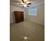 Bedroom with glossy tile floors, neutral walls, a closet, and a ceiling fan at 1412 Sunset Ln, Lutz, FL 33549
