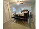Bright bedroom with mirrored closet doors, ceiling fan and windows at 1412 Sunset Ln, Lutz, FL 33549