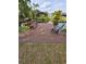 Private wooden dock with bench seating and chair, overlooking a tranquil pond surrounded by lush greenery at 1412 Sunset Ln, Lutz, FL 33549