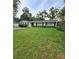 Well-manicured front yard with lush green grass and neatly trimmed hedges, enhancing curb appeal at 1412 Sunset Ln, Lutz, FL 33549