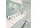 Spa-like bathroom featuring double sinks, sleek vanities, and glass-enclosed shower at 1415 Beach Club, Apollo Beach, FL 33572