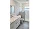 Modern bathroom featuring a vanity with marble countertop and tiled shower at 1415 Beach Club, Apollo Beach, FL 33572