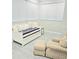 Bright room features a cozy daybed with accent pillows, chair, and footstool at 1415 Beach Club, Apollo Beach, FL 33572