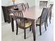Elegant dining room with wood table, chairs, and sideboard at 1415 Beach Club, Apollo Beach, FL 33572