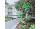 Landscaped front entrance with beautiful bushes and trees surrounding the walkway at 1415 Beach Club, Apollo Beach, FL 33572