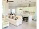 Bright, open-concept living area with a modern kitchen and luxury vinyl flooring at 1415 Beach Club, Apollo Beach, FL 33572