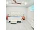 Serene primary bedroom with neutral decor, tray ceilings, and ceiling fan at 1415 Beach Club, Apollo Beach, FL 33572