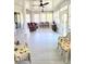 Spacious sunroom with wicker chairs, classic red chairs, and ceiling fans at 1415 Beach Club, Apollo Beach, FL 33572